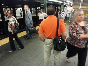 8 am - man in orange shirt proclaims, 'Today is the Day of Salvation!' to unconvinced audience