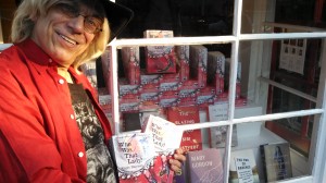 My dear friend John Farrell outside the bookstore window crammed with copies